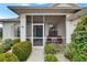 Inviting screened front porch with seating area, showcasing charming curb appeal and a cozy entrance at 2258 Preservation Green Ct, Sun City Center, FL 33573