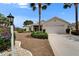 Well-maintained home featuring a two-car garage, manicured lawn, and mature landscaping at 2258 Preservation Green Ct, Sun City Center, FL 33573