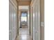 Hallway looking into bathroom with wallpaper and decorative window at 2258 Preservation Green Ct, Sun City Center, FL 33573