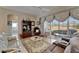 Comfortable living room with neutral tones and access to a sunroom, perfect for relaxation at 2258 Preservation Green Ct, Sun City Center, FL 33573