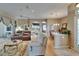 Open-concept living room with hardwood floors connects to a dining area and kitchen at 2258 Preservation Green Ct, Sun City Center, FL 33573