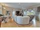 Bright living room featuring hardwood floors and neutral tones, flowing to an outdoor sunroom at 2258 Preservation Green Ct, Sun City Center, FL 33573