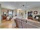 Spacious living room featuring hardwood floors flows to dining area, creating an open feel at 2258 Preservation Green Ct, Sun City Center, FL 33573