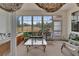 Bright sunroom with large windows and views of the serene outdoor landscape at 2258 Preservation Green Ct, Sun City Center, FL 33573