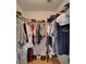 Walk-in closet with clothing racks on both sides and hardwood floors at 2258 Preservation Green Ct, Sun City Center, FL 33573