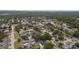 Wide aerial view of neighborhood with many mature trees surrounding homes at 3106 Ash Ct, Dunedin, FL 34698