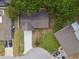 Aerial view of home with a long driveway, green grass and mature trees at 3106 Ash Ct, Dunedin, FL 34698