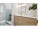 Bathroom featuring light wood cabinets, white quartz counters, gold hardware, and walk-in shower at 3106 Ash Ct, Dunedin, FL 34698