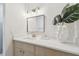 Contemporary bathroom with a modern vanity, updated mirror and lighting, and neutral color palette at 3106 Ash Ct, Dunedin, FL 34698
