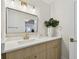 Bright bathroom featuring white quartz counters, light wood cabinets, and gold hardware at 3106 Ash Ct, Dunedin, FL 34698