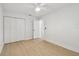 Bedroom with new flooring, baseboards, ceiling fan and large closet at 3106 Ash Ct, Dunedin, FL 34698