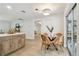 Bright dining area features a stylish round table, natural light, and easy access to the kitchen and outdoor spaces at 3106 Ash Ct, Dunedin, FL 34698