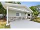Front of house featuring a covered entrance, freshly painted and stone accents at 3106 Ash Ct, Dunedin, FL 34698