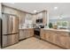 Well-equipped kitchen featuring stainless steel appliances, updated cabinets, and bright countertops at 3106 Ash Ct, Dunedin, FL 34698