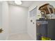 Laundry room features a water heater, new tile baseboard, and flooring at 3106 Ash Ct, Dunedin, FL 34698