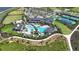 Aerial view showcasing community amenities including a pool, tennis courts, and green spaces at 33284 Castaway Loop, Wesley Chapel, FL 33543