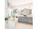 Bright bathroom featuring a soaking tub, walk-in shower, and double sink vanity at 33284 Castaway Loop, Wesley Chapel, FL 33543