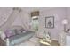 Charming bedroom featuring a princess-themed bed with a decorative crown and fantasy artwork at 33284 Castaway Loop, Wesley Chapel, FL 33543