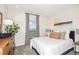 Well-lit bedroom with a large window, neutral tones, and comfortable bedding at 33284 Castaway Loop, Wesley Chapel, FL 33543