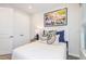 Cozy bedroom with white bedding, stylish pillows, and closet for ample storage at 33284 Castaway Loop, Wesley Chapel, FL 33543