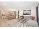 Open-concept living space with a modern kitchen, dining area, and a comfortable living room setup at 33284 Castaway Loop, Wesley Chapel, FL 33543