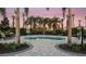 Relaxing community splash pool surrounded by palm trees and a patio area for lounging at 33284 Castaway Loop, Wesley Chapel, FL 33543