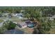 An aerial view of a home with a pool, solar panels and a large lot at 3344 Blythe Ave, Spring Hill, FL 34609