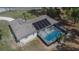 Aerial view of the home with pool and solar panels at 3344 Blythe Ave, Spring Hill, FL 34609