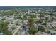Aerial view shows the home's location with pool within a suburban neighborhood with mature trees, marked with a red arrow at 3344 Blythe Ave, Spring Hill, FL 34609