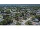 This aerial view presents the house in a neighborhood setting, surrounded by trees and other well-maintained homes at 3344 Blythe Ave, Spring Hill, FL 34609