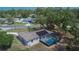 Aerial view of home with screened in pool, solar panels, and well-maintained landscaping at 3344 Blythe Ave, Spring Hill, FL 34609