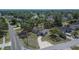 An aerial shot shows a single-story home with a screened pool and long driveway, surrounded by mature trees at 3344 Blythe Ave, Spring Hill, FL 34609