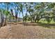 Large backyard with mature trees and plenty of space for outdoor activities at 3344 Blythe Ave, Spring Hill, FL 34609