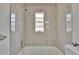 Bathroom boasts marble walls, shower, and bathtub at 3344 Blythe Ave, Spring Hill, FL 34609