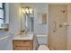 Bathroom with wood vanity, a shower and grab bars for accessibility, and a bright modern feel at 3344 Blythe Ave, Spring Hill, FL 34609