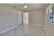 Bright and airy bedroom features gorgeous marble floors, a ceiling fan, and lots of natural light at 3344 Blythe Ave, Spring Hill, FL 34609