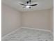 Bedroom boasts marble floors and modern ceiling fan at 3344 Blythe Ave, Spring Hill, FL 34609