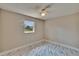 Empty bedroom with light colored walls, marble floors, and a bright window at 3344 Blythe Ave, Spring Hill, FL 34609