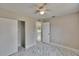 Bright bedroom features a ceiling fan, white marble floors, and closet space at 3344 Blythe Ave, Spring Hill, FL 34609