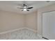 Empty bedroom features a dark ceiling fan, white marble floors, and closet at 3344 Blythe Ave, Spring Hill, FL 34609