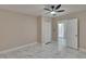 This bedroom offers fresh paint, gorgeous marble floors, and a ceiling fan at 3344 Blythe Ave, Spring Hill, FL 34609