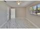 This bedroom is light and bright with pretty marble floors and a ceiling fan at 3344 Blythe Ave, Spring Hill, FL 34609