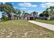 Charming home exterior with a curved entrance and a brown garage door, surrounded by a green lawn at 3344 Blythe Ave, Spring Hill, FL 34609