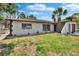 Charming single-story home featuring a well-manicured lawn and mature palm trees at 3344 Blythe Ave, Spring Hill, FL 34609