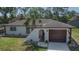 An inviting home showcasing clean lines, a tile roof, and a well-manicured lawn, set in a serene neighborhood at 3344 Blythe Ave, Spring Hill, FL 34609