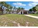 Home with manicured lawn, featuring a modern garage door and palm tree, blending suburban charm with tropical flair at 3344 Blythe Ave, Spring Hill, FL 34609