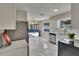 Bright kitchen features white cabinets, stainless steel appliances, quartz countertops, and stylish marble flooring at 3344 Blythe Ave, Spring Hill, FL 34609