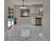 Open floor plan from dining to the kitchen and view of the pool at 3344 Blythe Ave, Spring Hill, FL 34609
