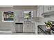 Bright kitchen features white cabinets, stainless steel appliances, quartz countertops, and stylish marble flooring at 3344 Blythe Ave, Spring Hill, FL 34609