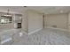 Bright, neutral living space showcasing open kitchen and modern flooring at 3344 Blythe Ave, Spring Hill, FL 34609